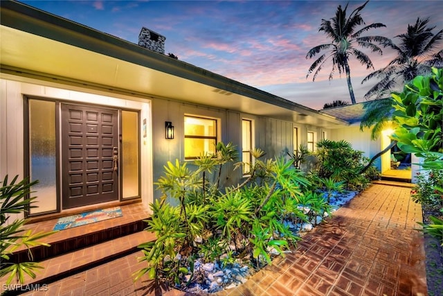 view of exterior entry at dusk