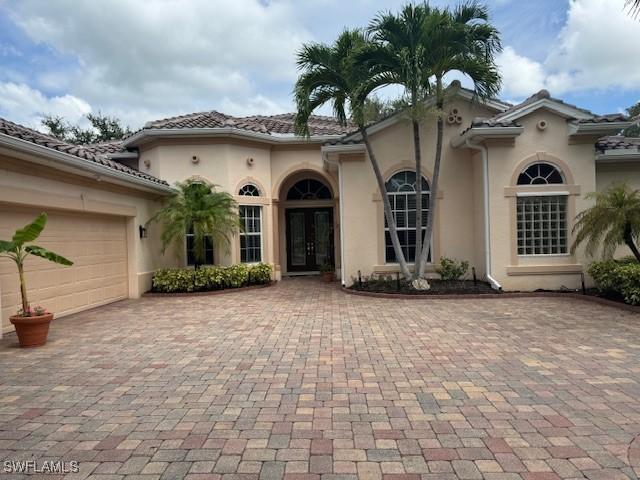 exterior space featuring a garage and french doors