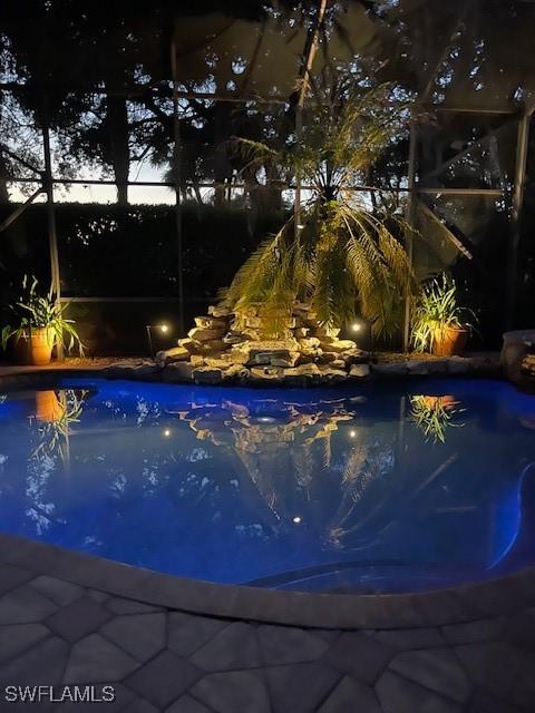 view of pool at dusk