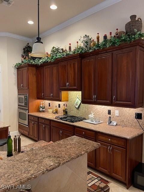 kitchen with stainless steel appliances, light stone counters, light tile patterned floors, pendant lighting, and crown molding