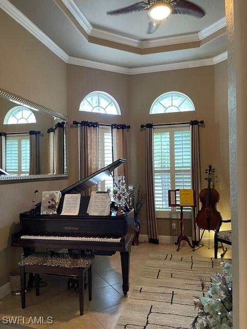 miscellaneous room featuring a raised ceiling, ornamental molding, and ceiling fan