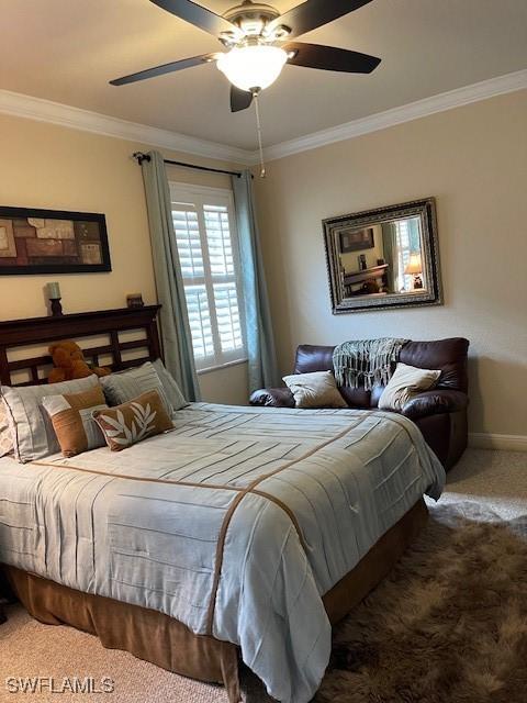 bedroom with ornamental molding, ceiling fan, and carpet flooring