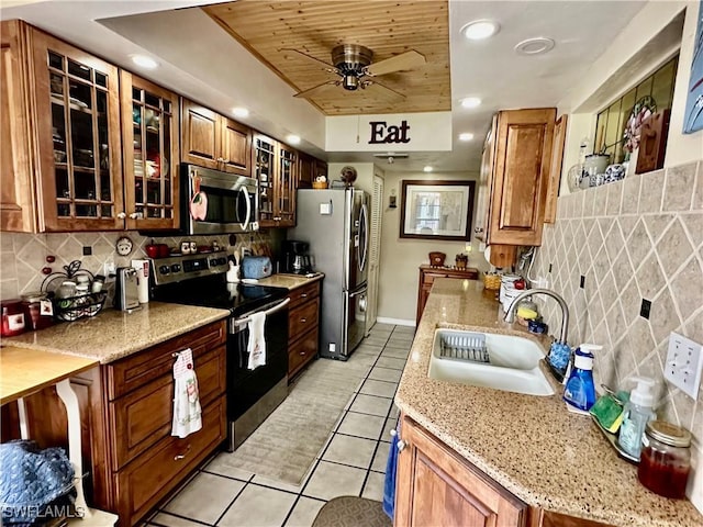 kitchen with tasteful backsplash, sink, light tile patterned flooring, appliances with stainless steel finishes, and wood ceiling