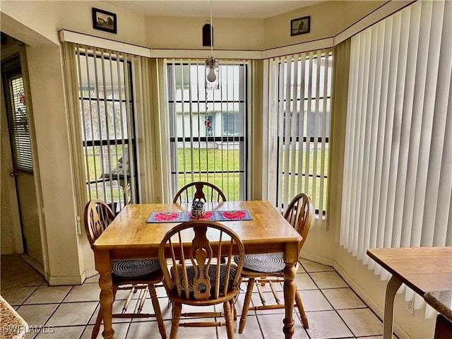 dining space with light tile patterned flooring and baseboards