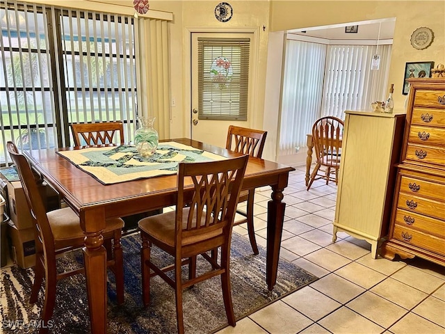 dining space featuring light tile patterned flooring