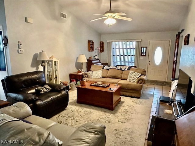 living area with visible vents, lofted ceiling, ceiling fan, and tile patterned flooring