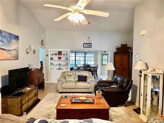 tiled living room featuring ceiling fan and high vaulted ceiling