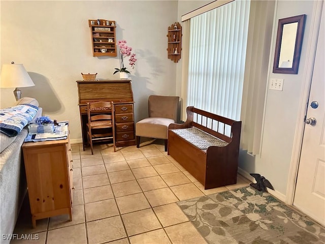 sitting room with light tile patterned floors and baseboards