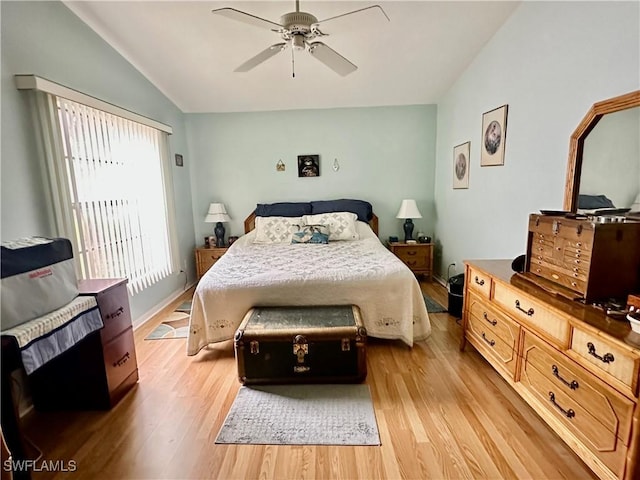 bedroom with ceiling fan, light hardwood / wood-style flooring, and lofted ceiling