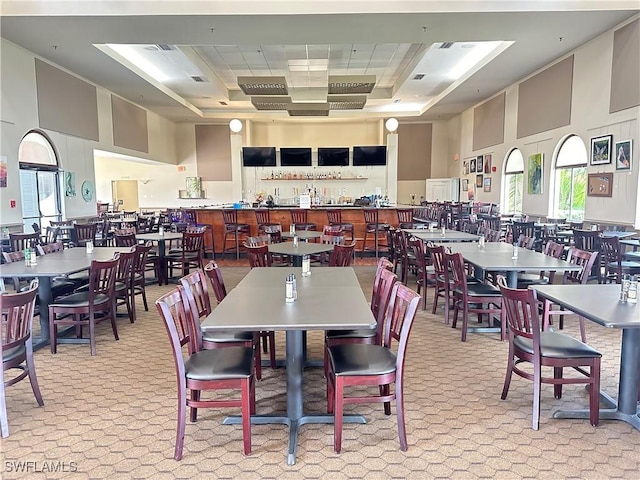 dining area featuring a towering ceiling