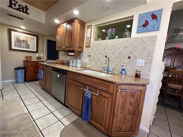 kitchen featuring visible vents, backsplash, dishwasher, and a sink