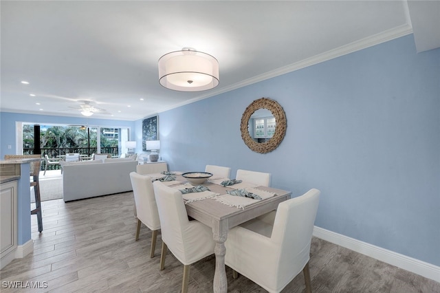 dining room with crown molding, light hardwood / wood-style floors, and ceiling fan