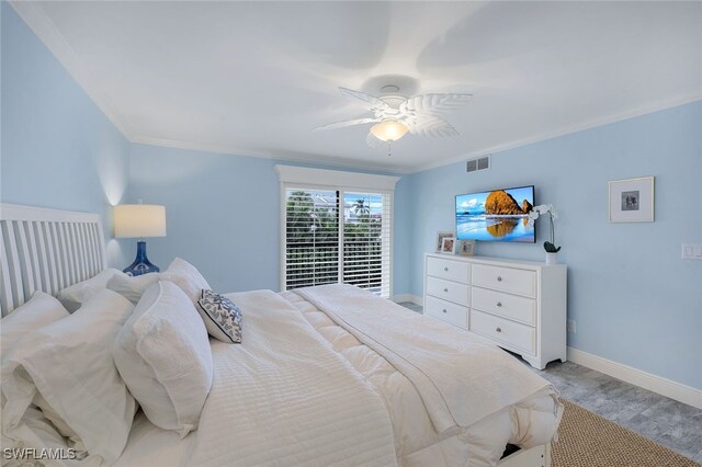 bedroom with light hardwood / wood-style flooring, ornamental molding, and ceiling fan