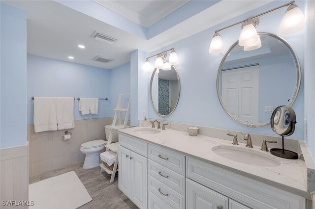 bathroom with ornamental molding, toilet, hardwood / wood-style floors, and vanity