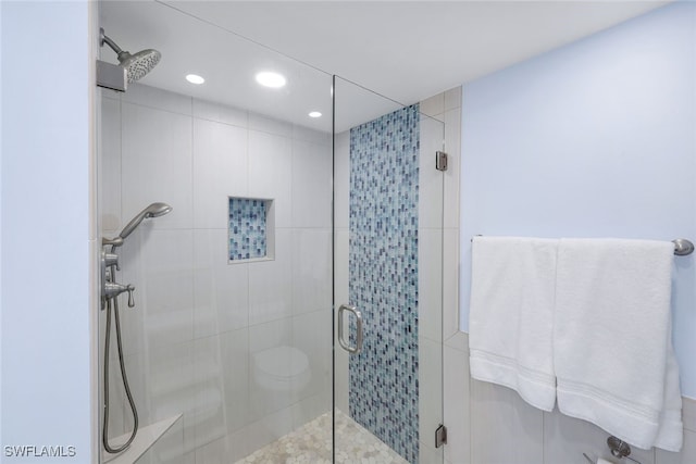 bathroom featuring recessed lighting and a shower stall