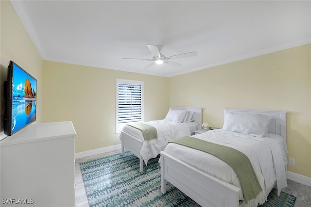 bedroom featuring ceiling fan, baseboards, and crown molding