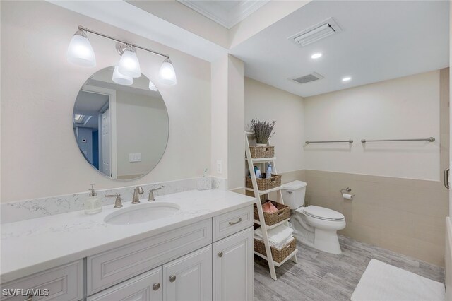 bathroom featuring vanity, wood-type flooring, and toilet