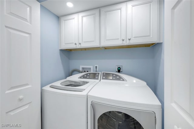 washroom with cabinets and independent washer and dryer