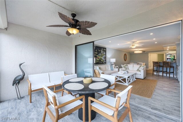 dining area with ceiling fan and light wood-type flooring