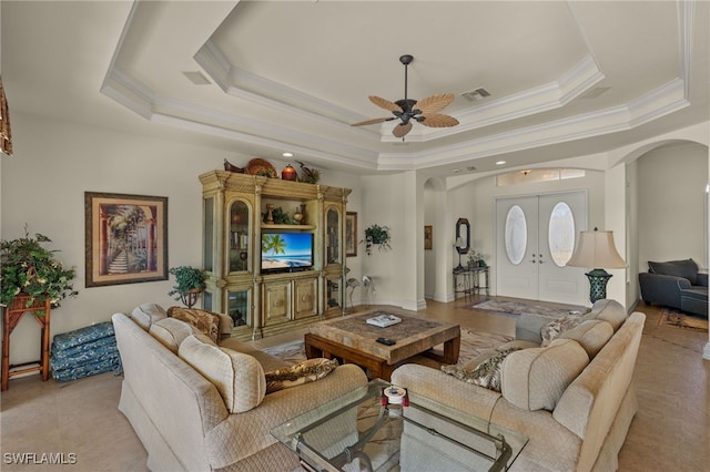 living room with french doors, crown molding, ceiling fan, and a tray ceiling