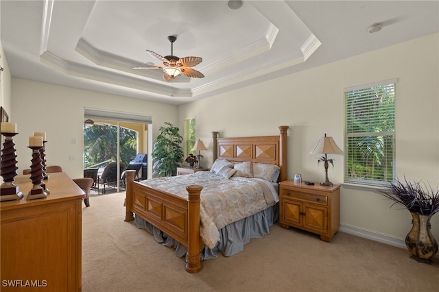 carpeted bedroom with ceiling fan, ornamental molding, a raised ceiling, and access to outside