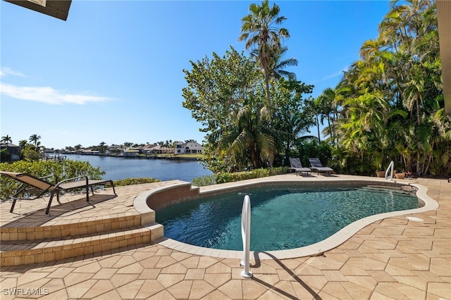 view of pool with a patio and a water view