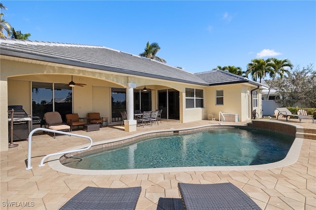 view of swimming pool featuring area for grilling, a patio, and ceiling fan