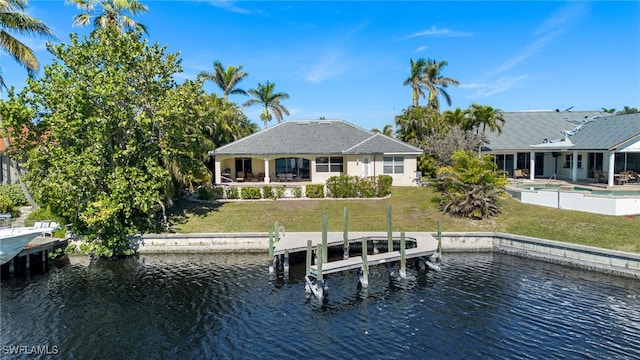 dock area with a water view and a lawn