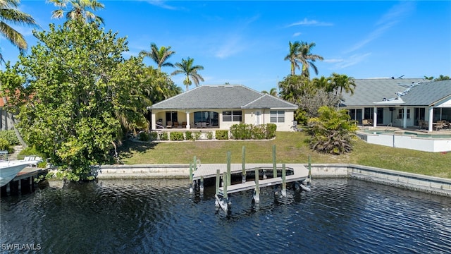 view of dock featuring an outdoor pool, a water view, and a lawn