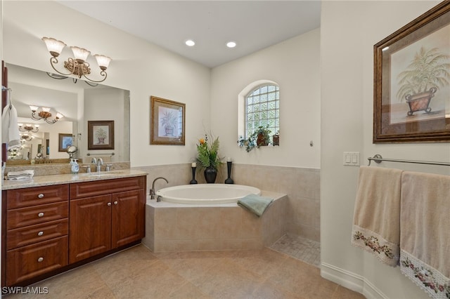 bathroom with vanity, tile patterned flooring, and a relaxing tiled tub