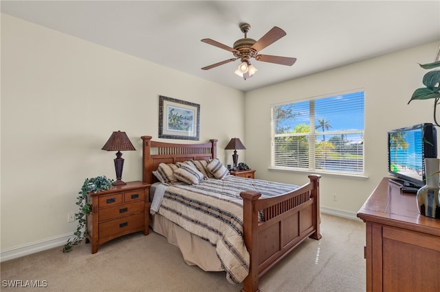 bedroom featuring light colored carpet and ceiling fan