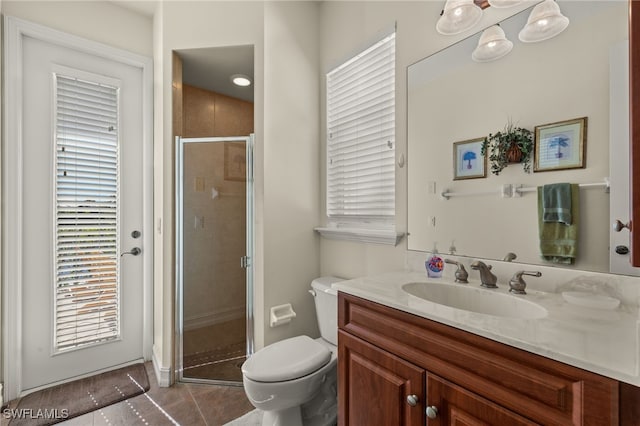 bathroom with vanity, tile patterned flooring, a shower with door, and toilet