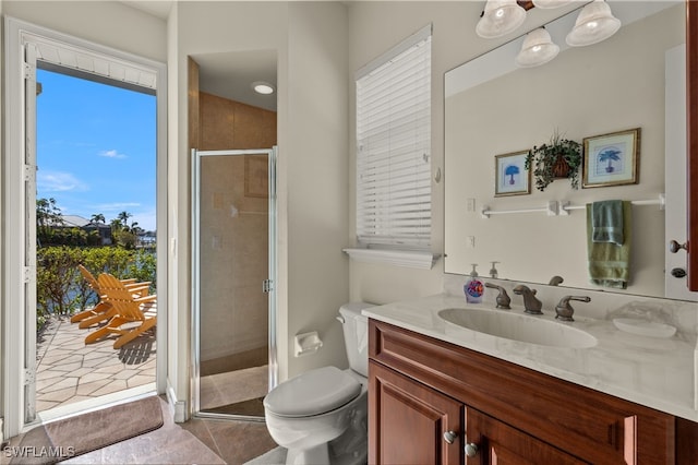 bathroom featuring tile patterned flooring, toilet, vanity, and walk in shower