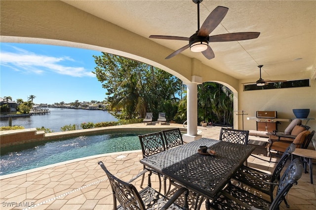 view of patio / terrace featuring a water view and ceiling fan