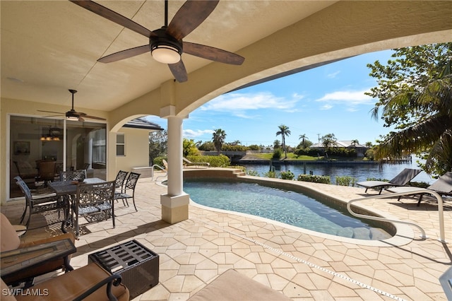 view of pool with a patio area and a water view