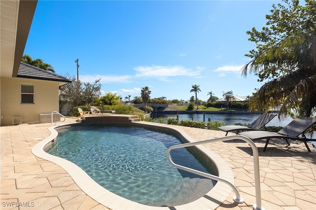 view of swimming pool with a patio and a water view