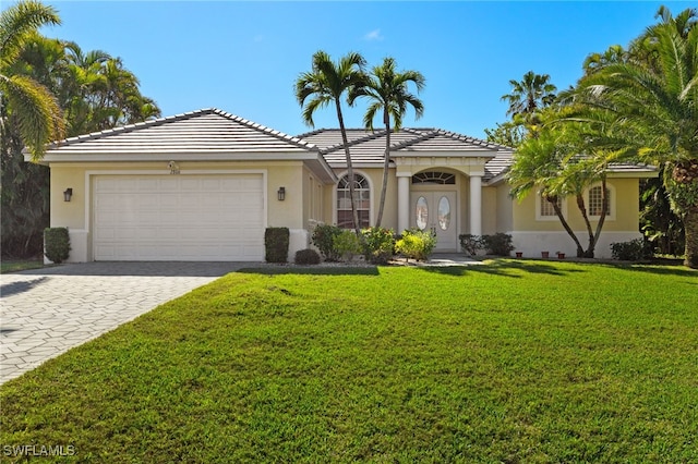 view of front of home featuring a garage and a front lawn