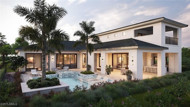 rear view of house featuring a patio area, an in ground hot tub, and exterior bar