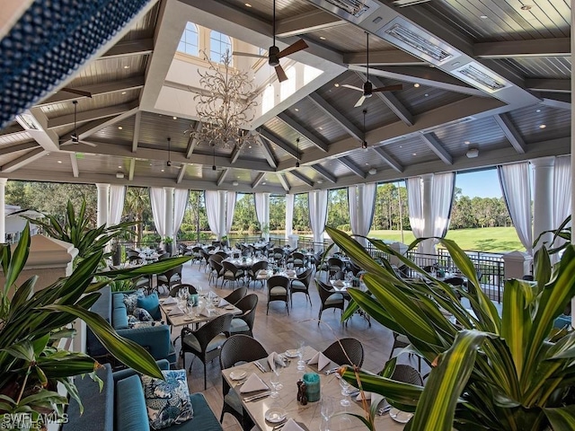 sunroom featuring ceiling fan and beam ceiling