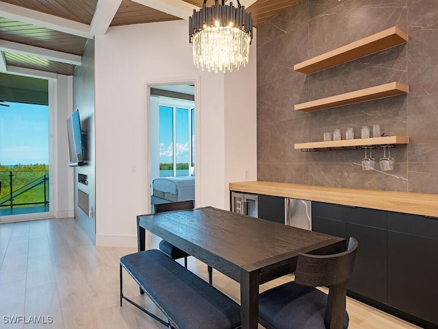 dining space featuring wood ceiling, a chandelier, light wood-type flooring, and beamed ceiling