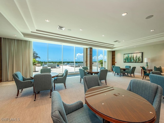 carpeted dining room featuring expansive windows