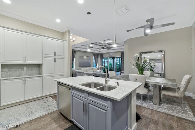 kitchen featuring sink, white cabinetry, dishwasher, pendant lighting, and a kitchen island with sink