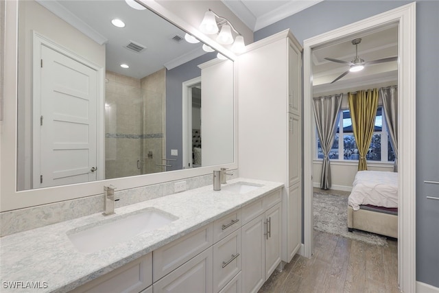 bathroom featuring wood-type flooring, vanity, ceiling fan, walk in shower, and crown molding