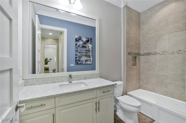 full bathroom with hardwood / wood-style floors, tiled shower / bath combo, vanity, toilet, and crown molding