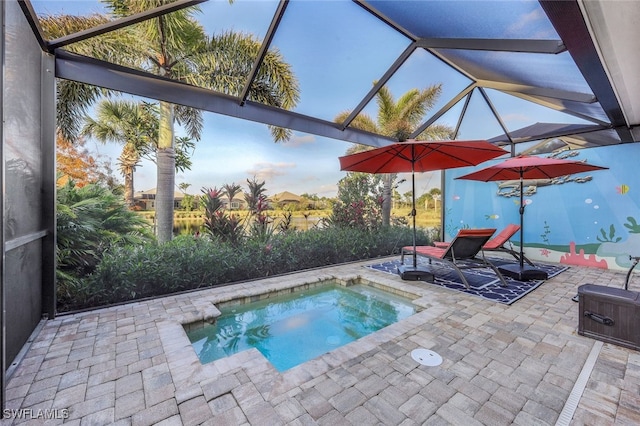 view of pool with a patio and glass enclosure