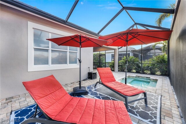 view of patio / terrace with a lanai and a jacuzzi