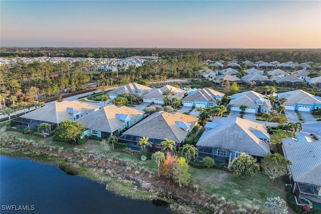 aerial view at dusk with a water view