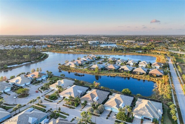 aerial view at dusk with a water view