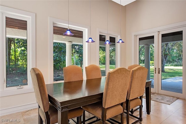 tiled dining area featuring plenty of natural light and french doors