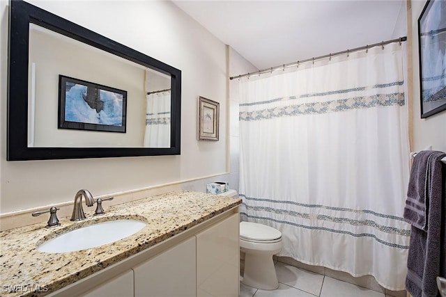 bathroom with toilet, tile patterned floors, and vanity